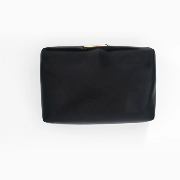 A black faux-leather pouch, lifted out of the shell.