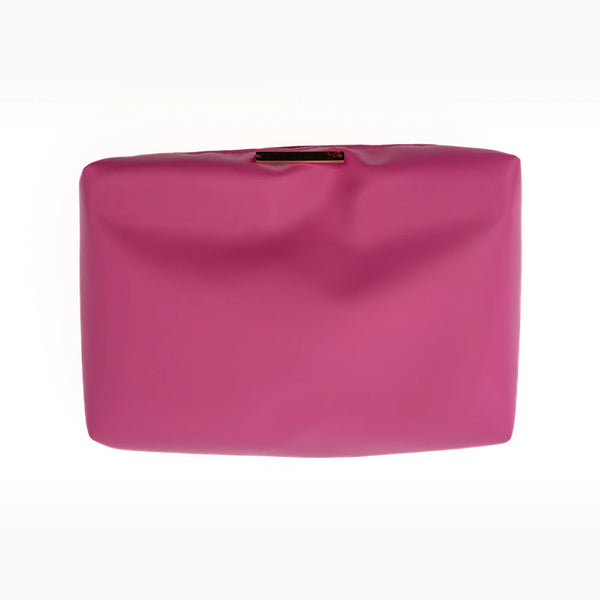 A fuchsia faux-leather pouch, lifted out of the shell.