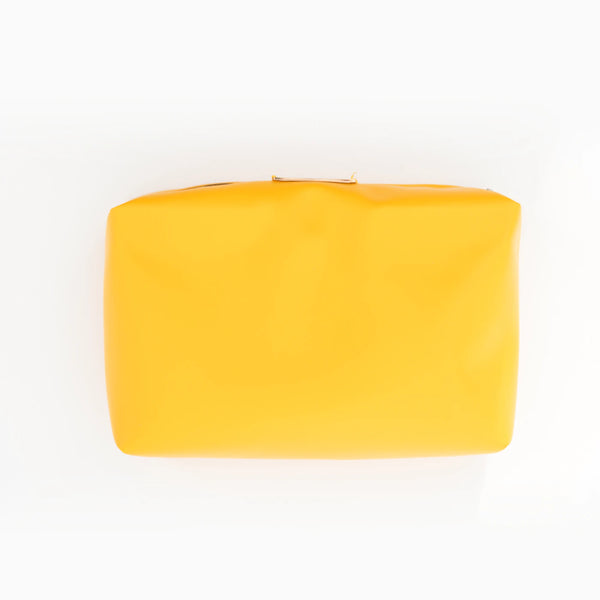 A yellow faux-leather pouch, lifted out of the shell.